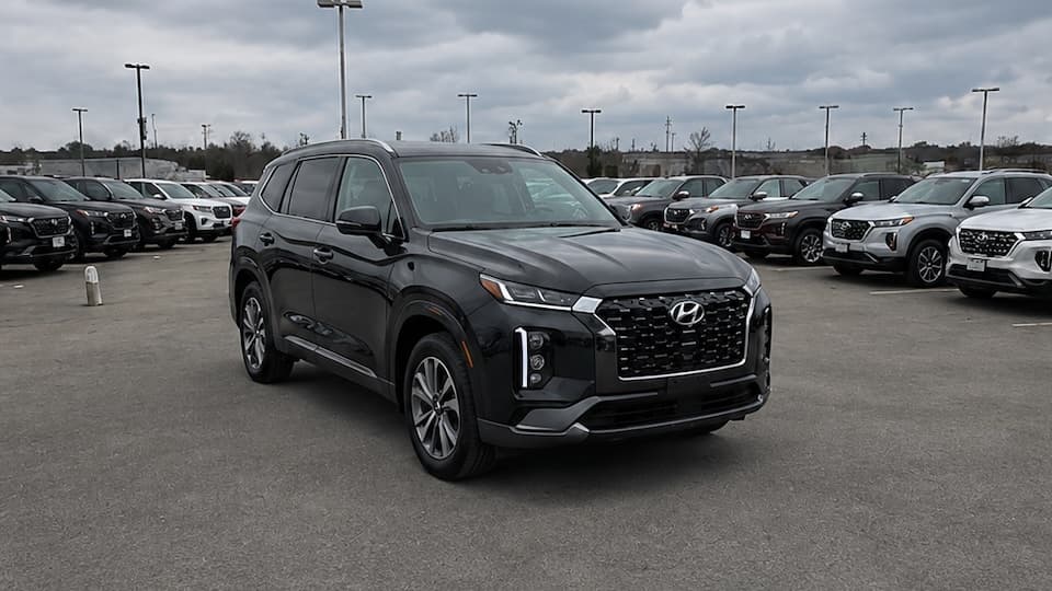 Black Hyundai Palisade photographed in a dealership lot